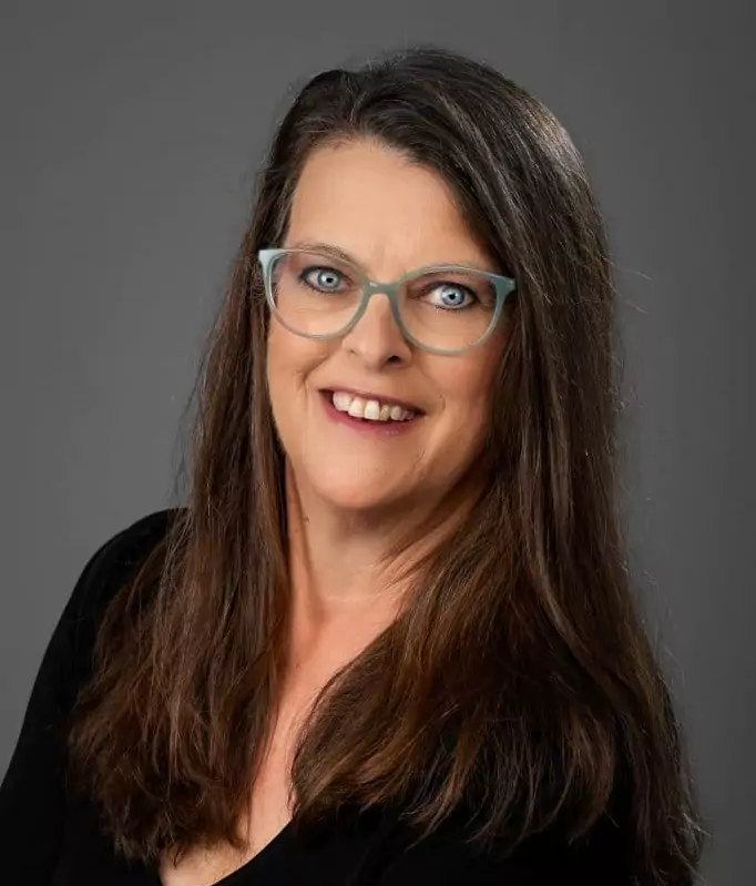 A portrait of a smiling woman wearing glasses, lisa white of mason llp