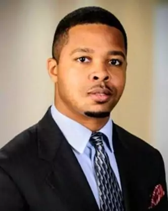 A man wearing a suit and tie named Ra Amen for Mason LLP