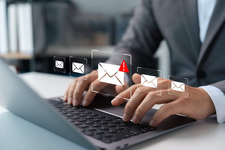 Man on laptop investigating email cybersecurity data breach - congressional budget office cyber incident